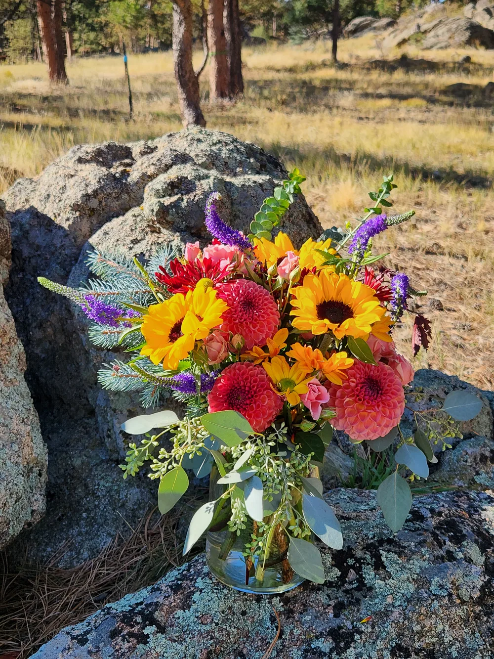 Colorful wildflower bouquet in nature setting.