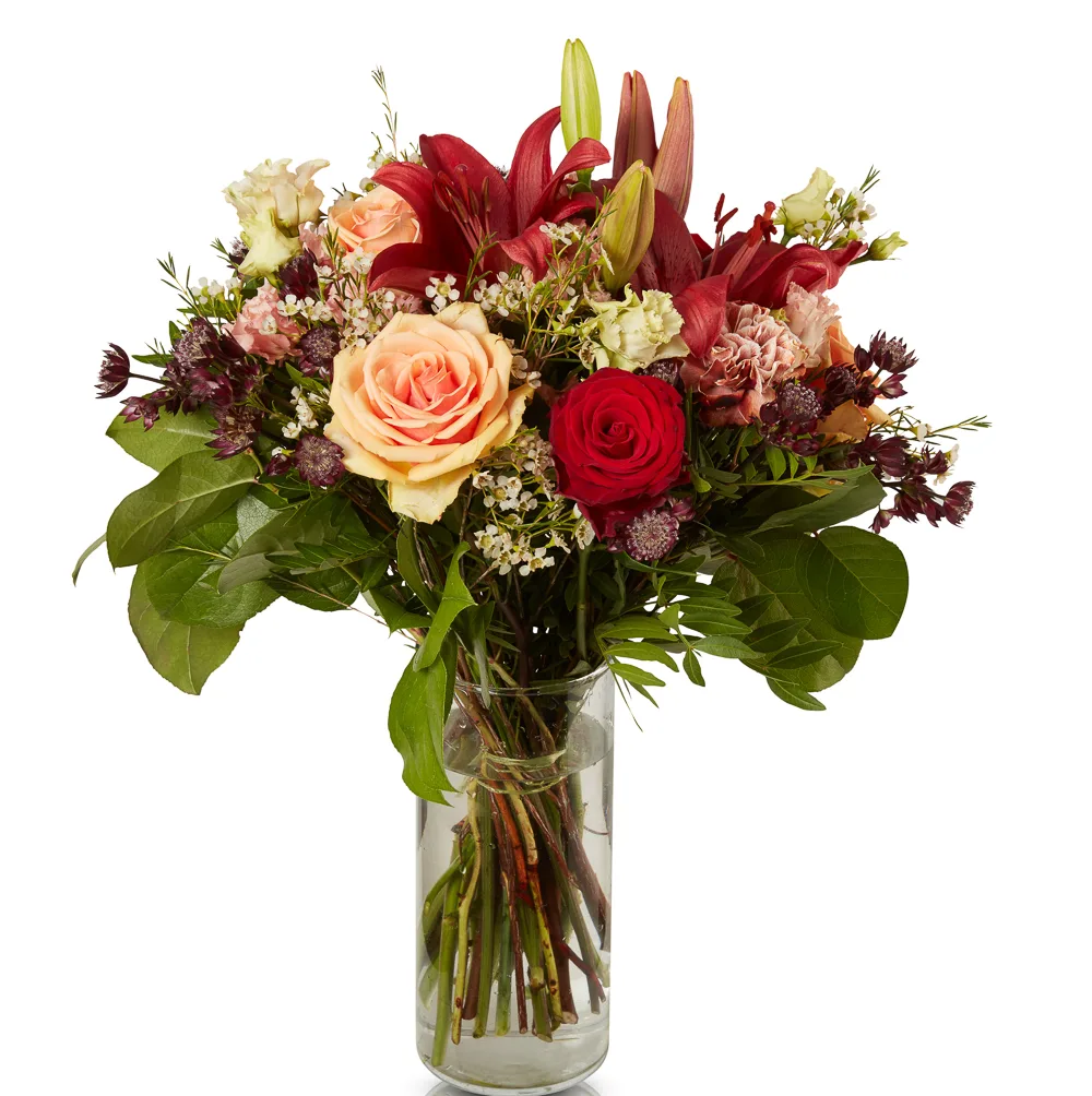 Vibrant floral bouquet in clear vase.